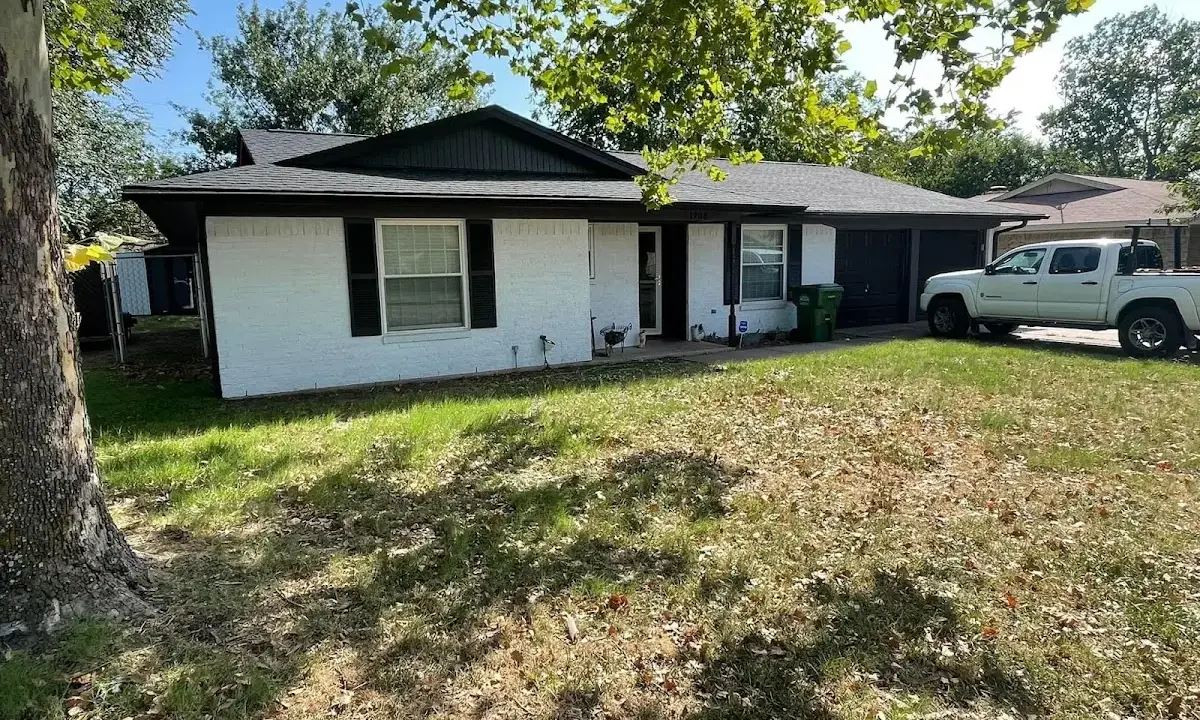 Professional roofing crew working on a residential roof in West Earl